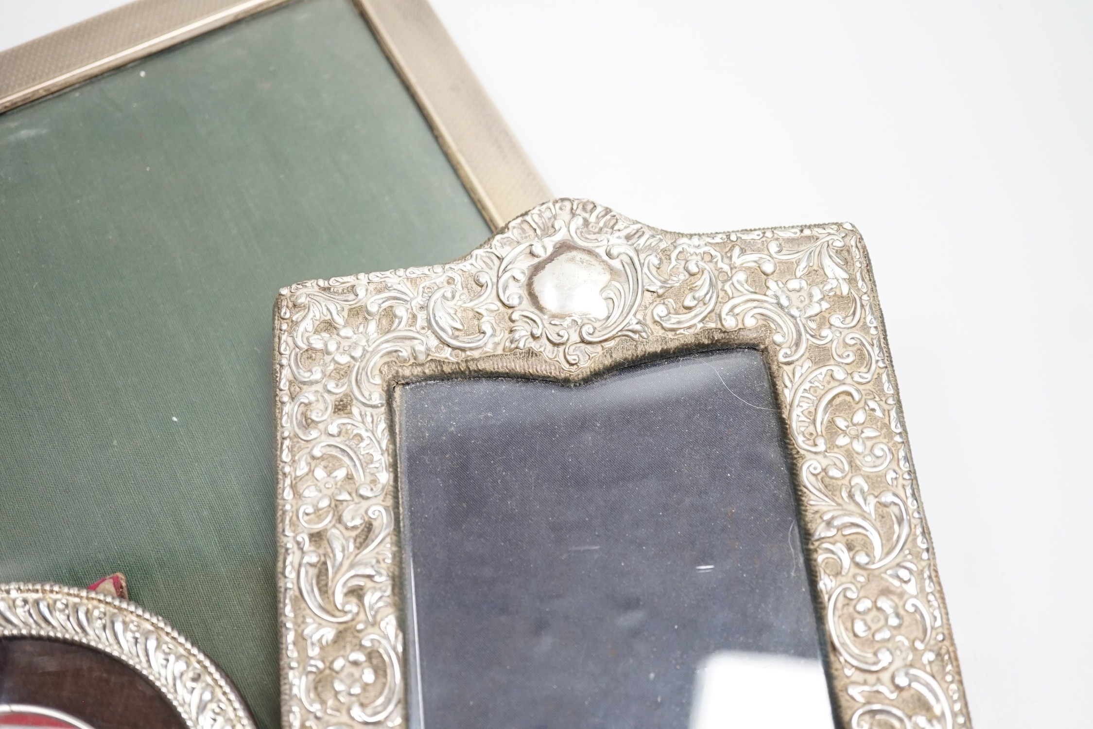 A large 1920's engine turned silver mounted rectangular photograph frame, Birmingham, 1928, 33.2cm and two other silver mounted photograph frames including circular.